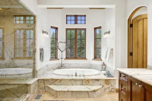 Bathroom featuring vanity and a bath