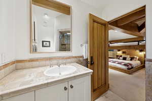 Bathroom featuring vanity and ensuite bath