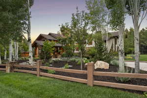 View of front of house with a fenced front yard and a shingled roof