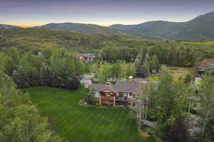 Aerial view of property and surrounding area featuring mountains