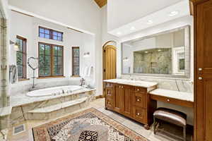 Full bath featuring inlaid floor details, a marble finish shower, a garden tub, vanity, and recessed lighting