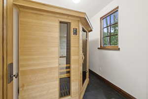 Relaxing sauna featuring baseboards and carpet