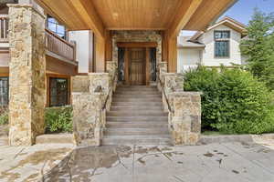 Entrance to property with stone siding