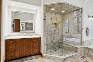 Full bath featuring a marble finish shower, vanity, a bath, and recessed lighting