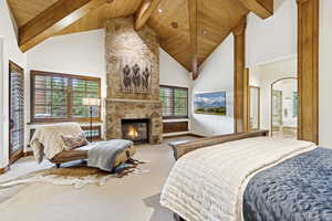Bedroom featuring carpet, a fireplace, high vaulted ceiling, and a wooden ceiling with exposed beams