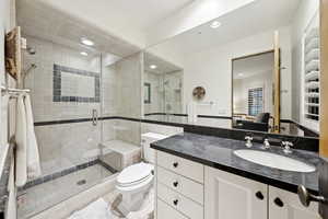 Bathroom with vanity, ensuite bathroom, a shower stall, recessed lighting, and tile patterned floors