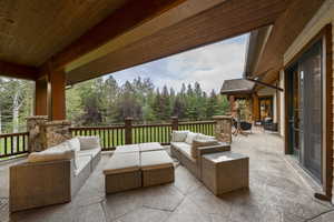 View of patio / terrace with an outdoor hangout area and view of scattered trees