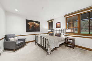 Bedroom featuring baseboards and carpet