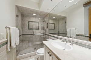Bathroom with vanity, tile walls, and a shower stall