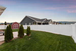 Fenced backyard with a storage shed