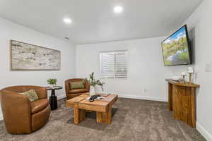 Living room with carpet floors and recessed lighting