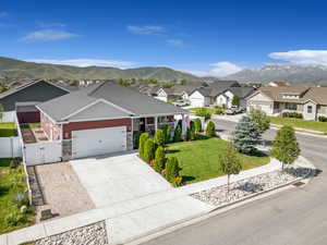 View of front facade with a gate, a garage, a mountain view, a residential view, and driveway