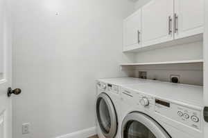 Laundry room featuring washer and dryer and cabinet space