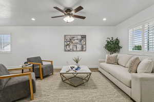 Living room featuring wood finished floors, recessed lighting, and a ceiling fan