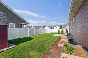Fenced backyard with a garden and a residential view