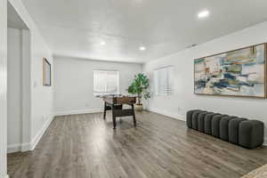 Office with wood finished floors, a textured ceiling, and recessed lighting