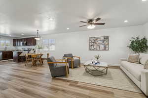 Living area with light wood finished floors, recessed lighting, and ceiling fan