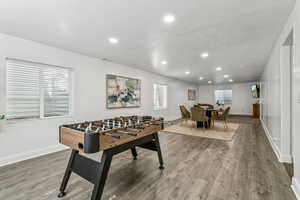 Playroom with recessed lighting, wood finished floors, and plenty of natural light