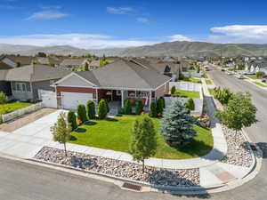 View of front of property featuring a residential view, a garage, a porch, and a mountain view