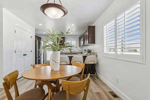 Dining room featuring light wood finished floors and recessed lighting