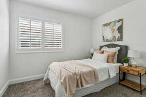 Bedroom featuring carpet flooring and multiple windows