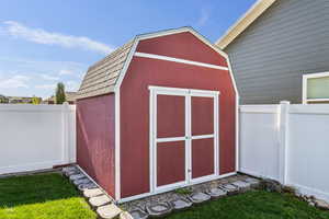 View of shed with a fenced backyard