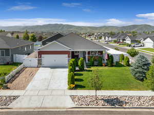 View of front of home featuring a gate, a residential view, an attached garage, and a mountain view