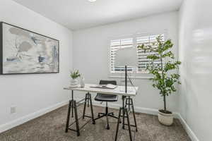 Carpeted home office with baseboards