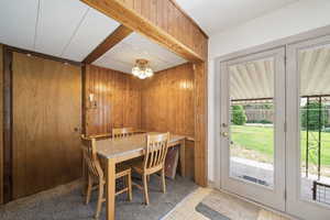 Dining area featuring wood walls