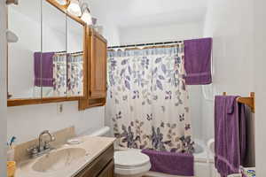 Full bath featuring vanity and shower / bathtub combination with curtain