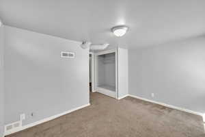 Unfurnished bedroom with carpet flooring and a closet