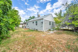 Back of property with a shingled roof