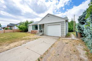 Ranch-style home featuring concrete driveway and a garage
