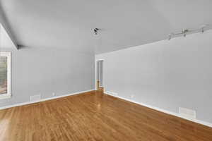 Bonus room with hardwood / wood-style floors and baseboards