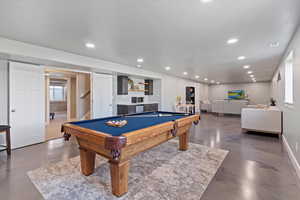 Recreation room with concrete flooring, pool table, recessed lighting, bar, and wine cooler