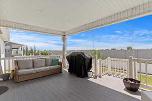 Wooden deck with outdoor lounge area and area for grilling