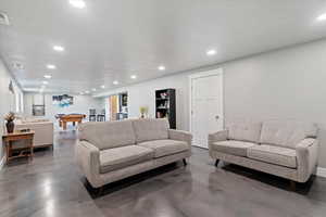 Living area featuring recessed lighting, concrete floors, and pool table
