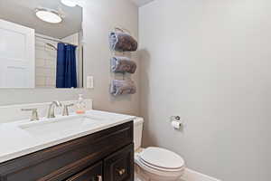 Full bath featuring vanity and curtained shower