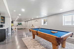 Rec room featuring recessed lighting, pool table, and finished concrete flooring