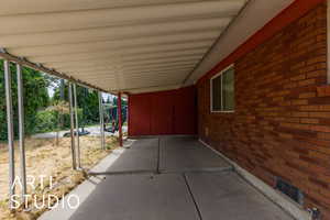 View of patio with a carport