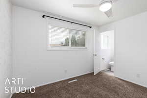 Unfurnished bedroom with carpet flooring, ensuite bathroom, and a ceiling fan