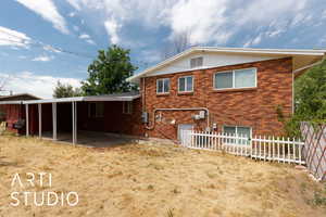 Back of house featuring brick siding and a patio area