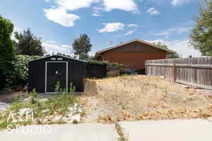 View of yard with a storage shed