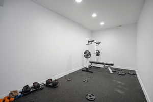 Workout area with baseboards and recessed lighting