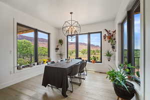 Dining area featuring a chandelier, light wood-style flooring, and a mountain view