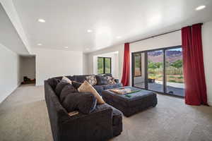 Carpeted living room with recessed lighting