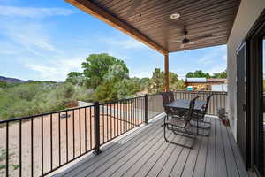 Deck with a ceiling fan and outdoor dining space