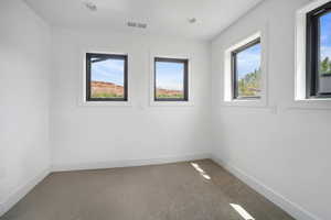Carpeted spare room with recessed lighting