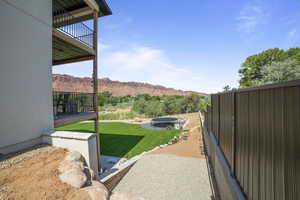 View of yard featuring a balcony and a mountain view