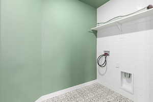 Laundry room featuring hookup for a washing machine and baseboards